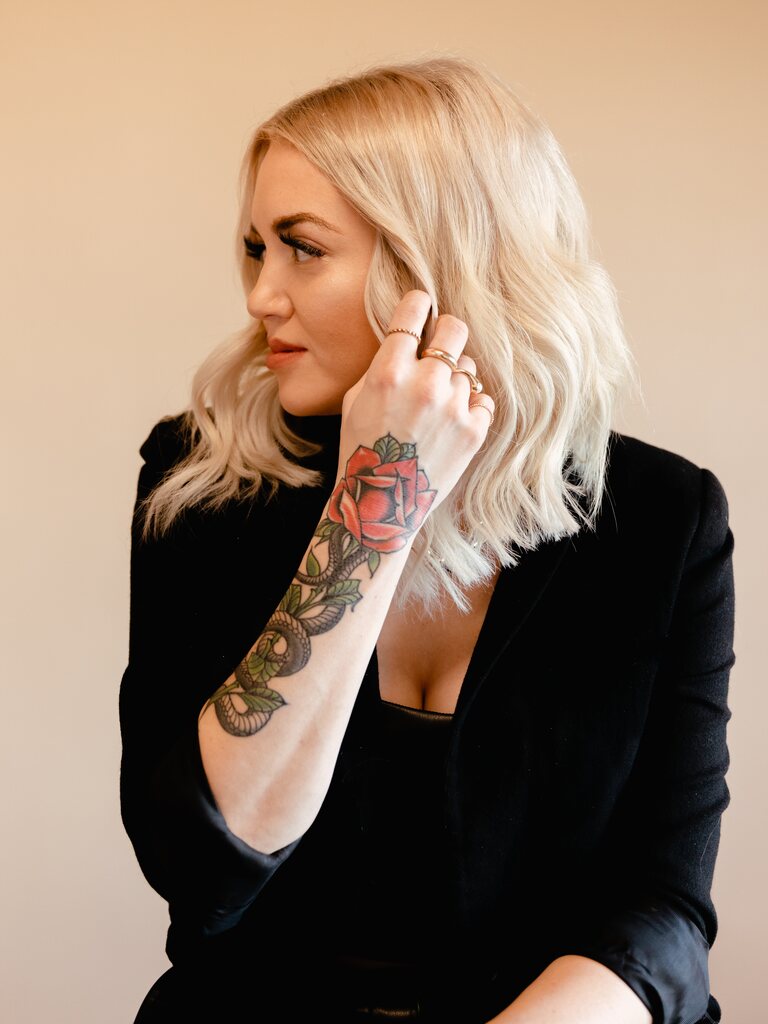 Rachel Hope in profile with her rose tattoo visible